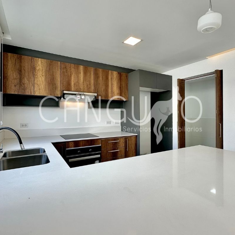 Cocina americana con mesones de cuarzo en casa de arriendo en Puembo