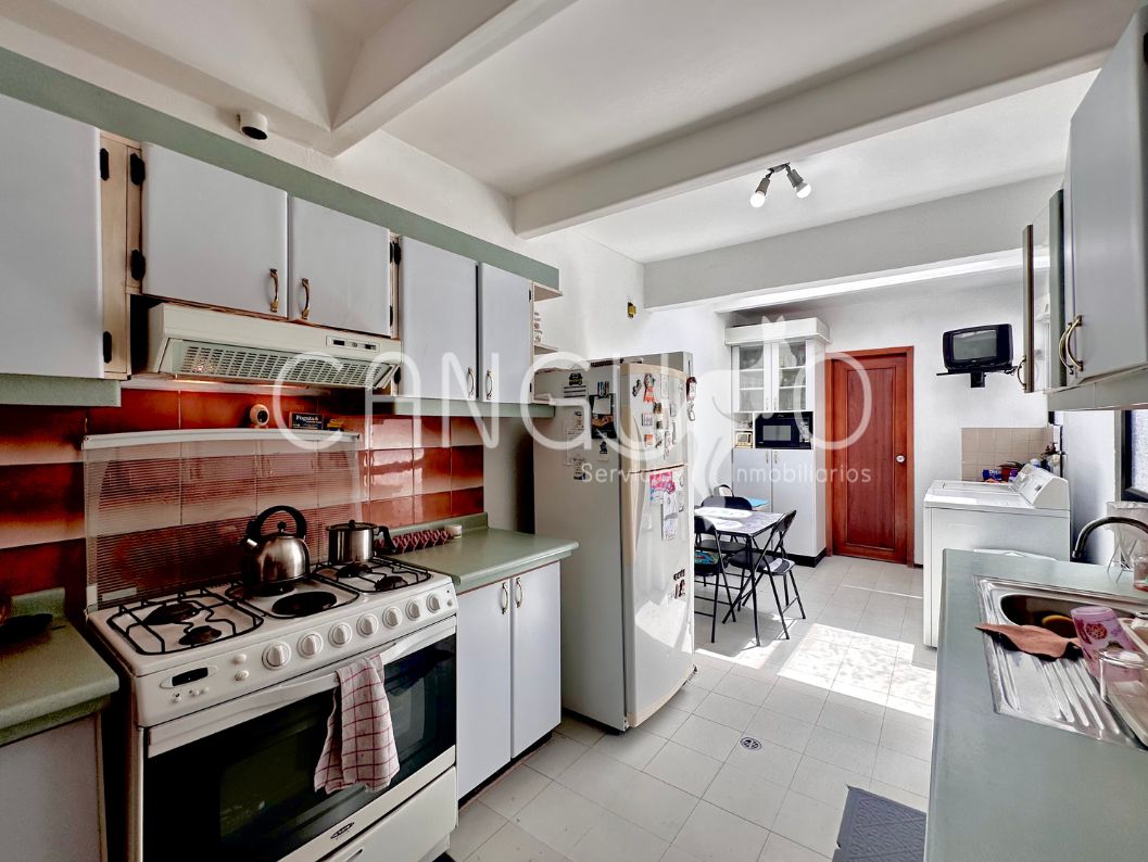 Cocina luminosa con área de máquinas en casa de California Alta